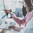 two people working in front of a computer.jpg